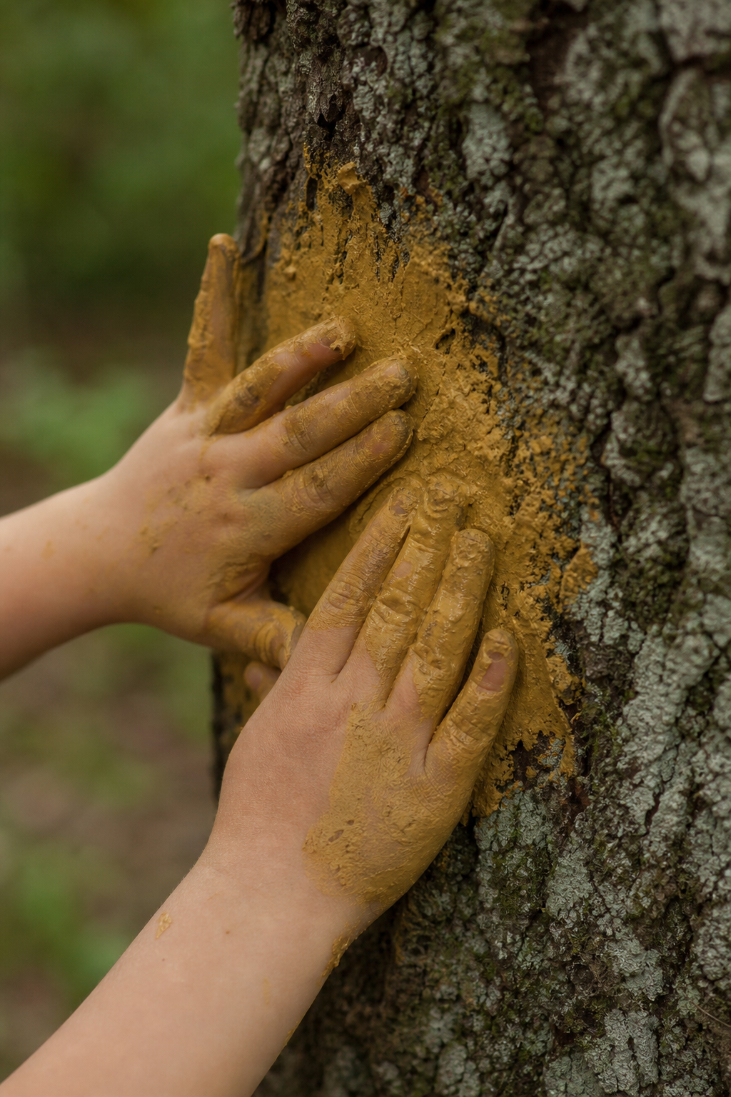 Children painting outdoors in the forest